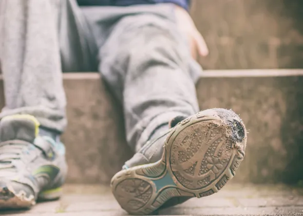 Child poverty worn out shoes