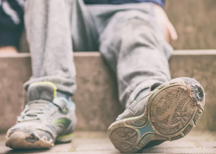 Child poverty worn out shoes