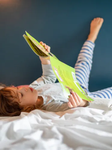 Girl reading a book at home